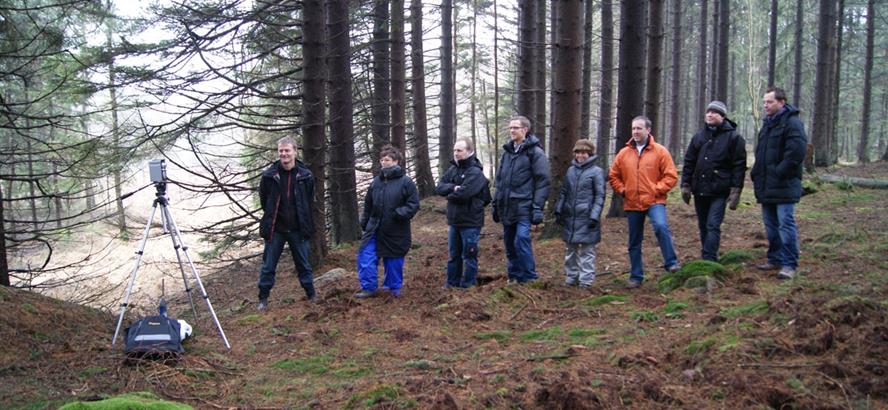 Ecophon school acoustics specialists in the forest taking measurements 