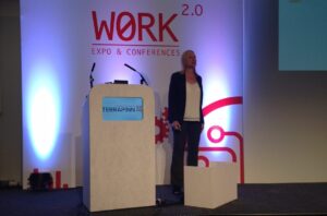 Paige Hodsman, expert in psychoacoustics, presenting on main stage at Work 2.0