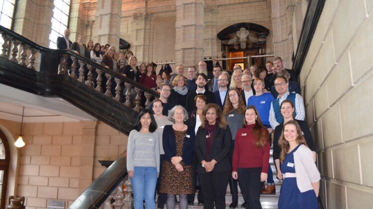 Group photo of iCARE project members in a grand stair case