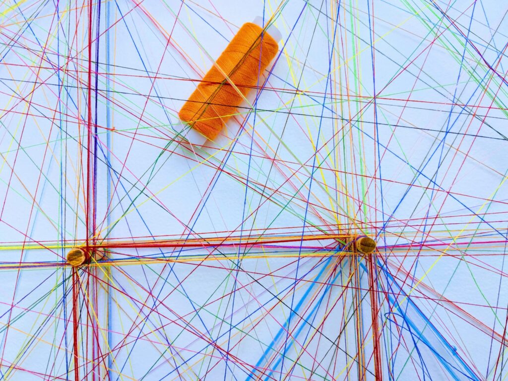 Coloured string crisscrossing over a borad