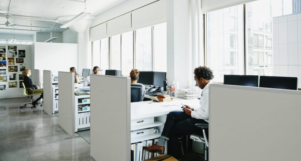 Businesspeople working at workstations in office