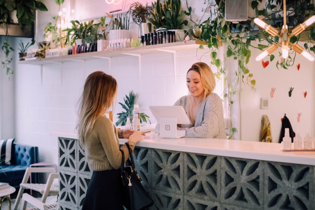 Woman and receptionist at counter